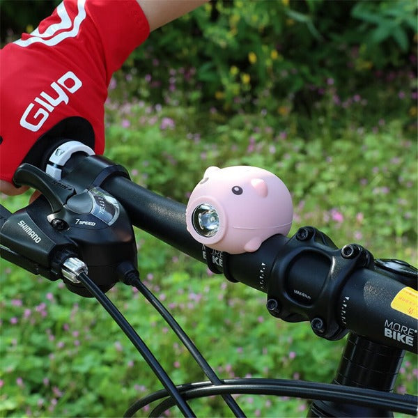 PIGGY Light & Bell - 3 Modes Children's Bicycle Handlebar Light and Bell - On bike.